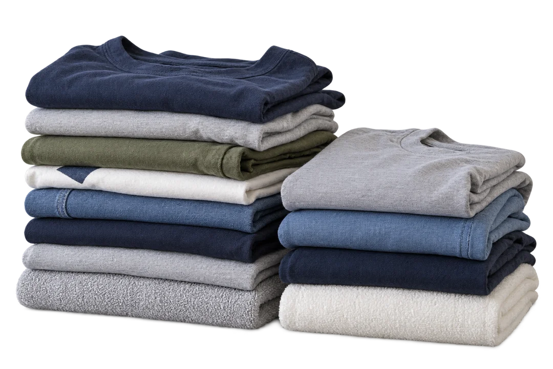 Two stacks of freshly folded everyday clothes and towels